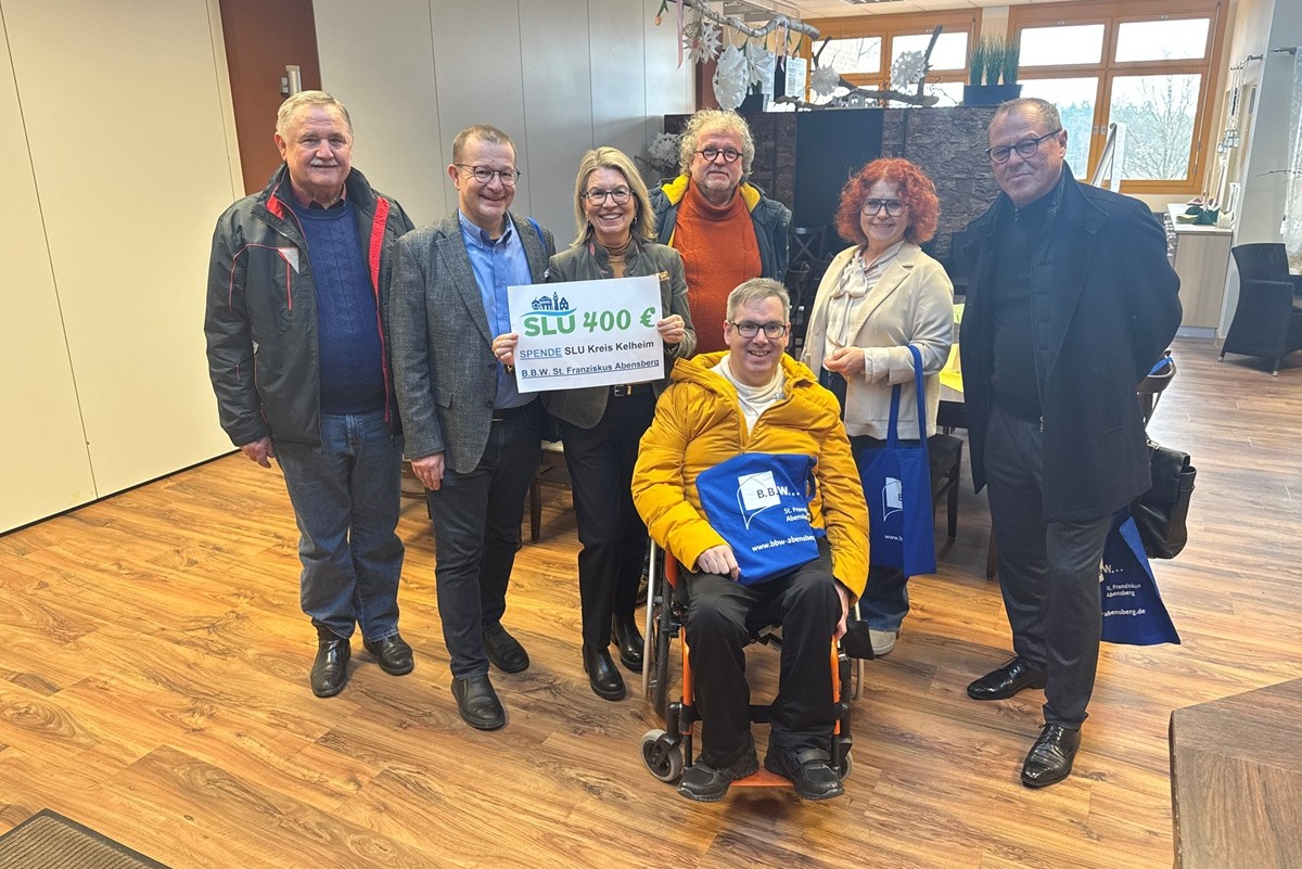 SLU Delegation bei der Übergabe de Spende im Bistro mit SCheck